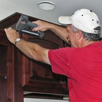 Bill Timlin installing cabinet crown molding