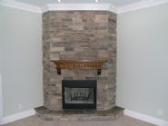 stacked stone fireplace by Acorn Fine Homes - Thumb Pic 25