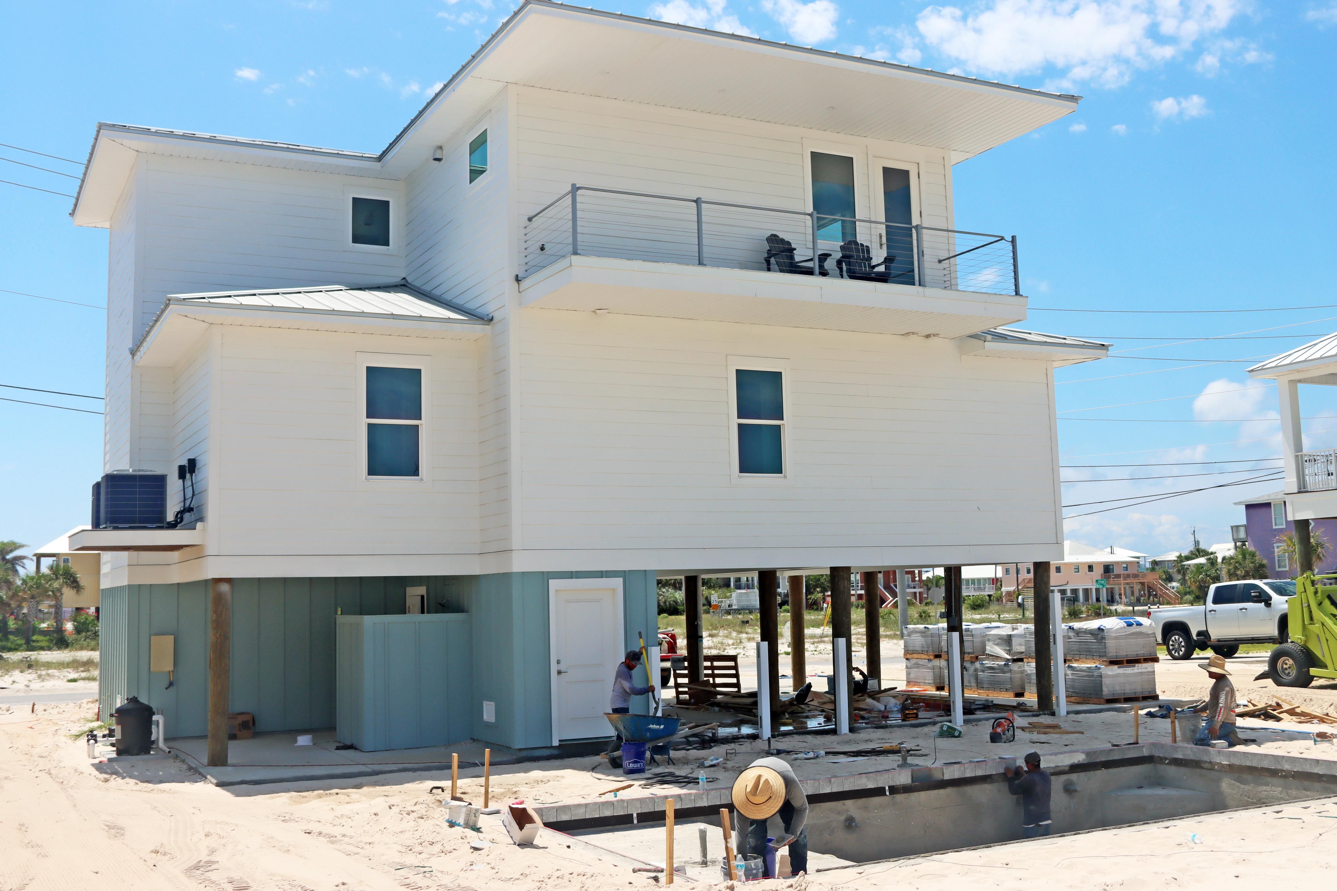 Modern coastal piling home in Navarre by Acorn Fine Homes