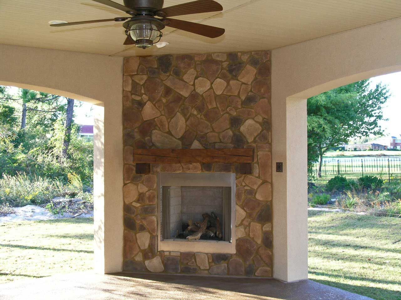 stone exterior fireplace by Acorn Construction