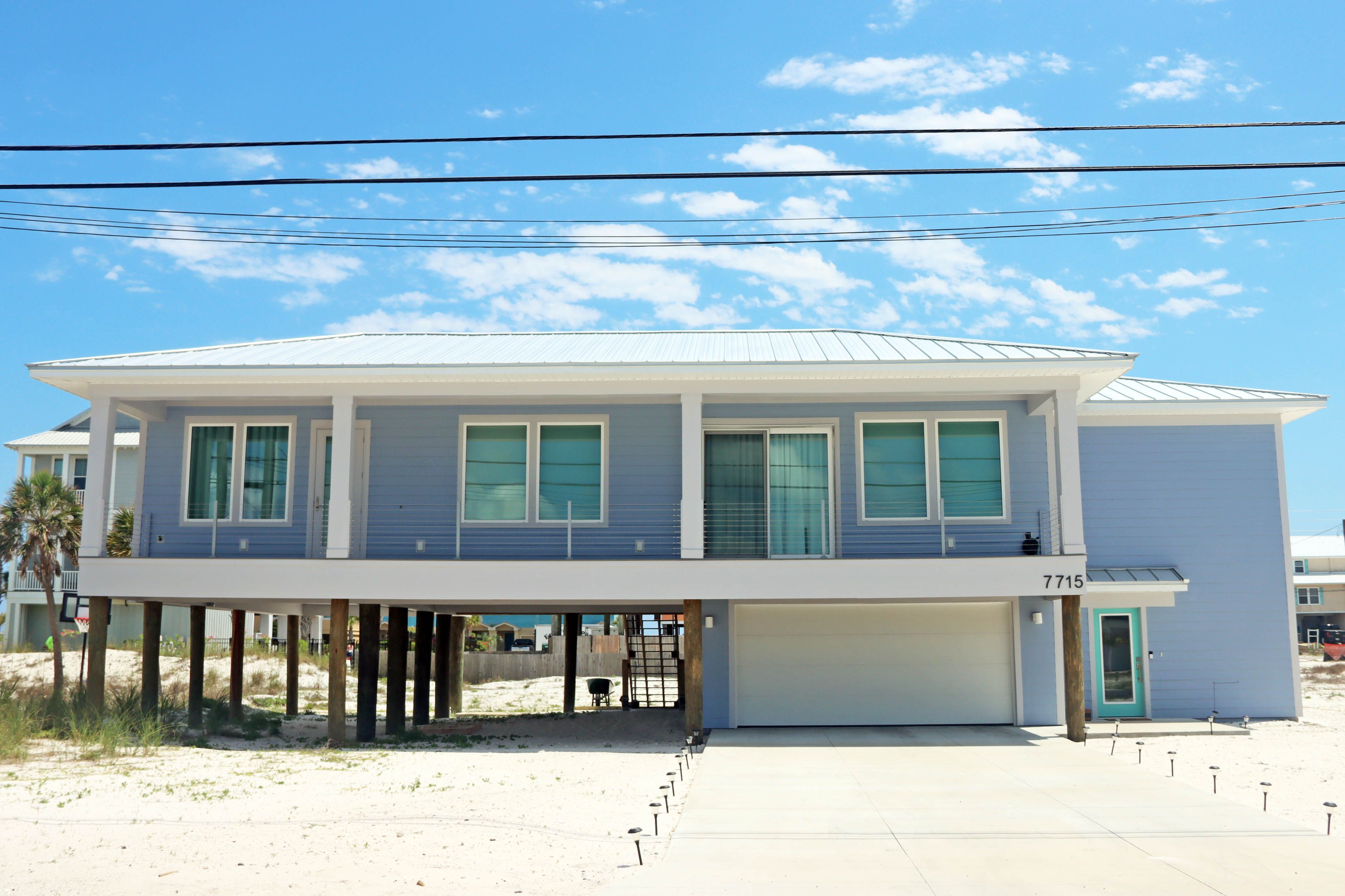 Modern coastal piling home in Navarre by Acorn Fine Homes