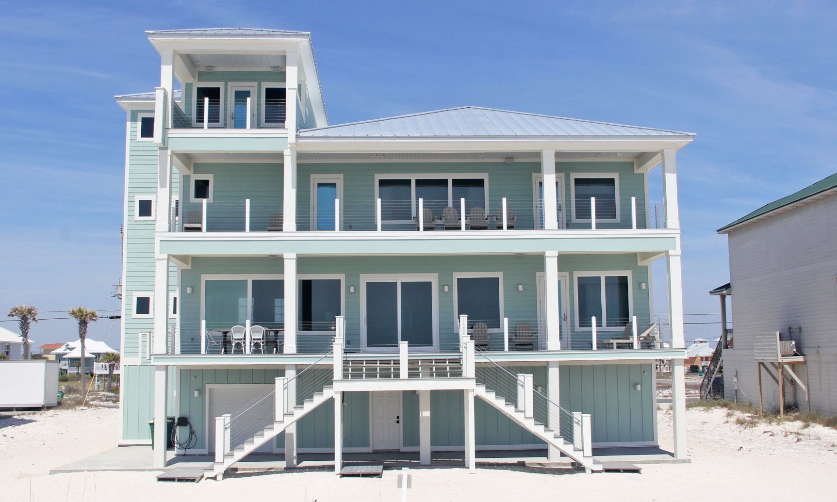 Antinnes modern coastal piling home on Navarre Beach by Acorn Fine Homes