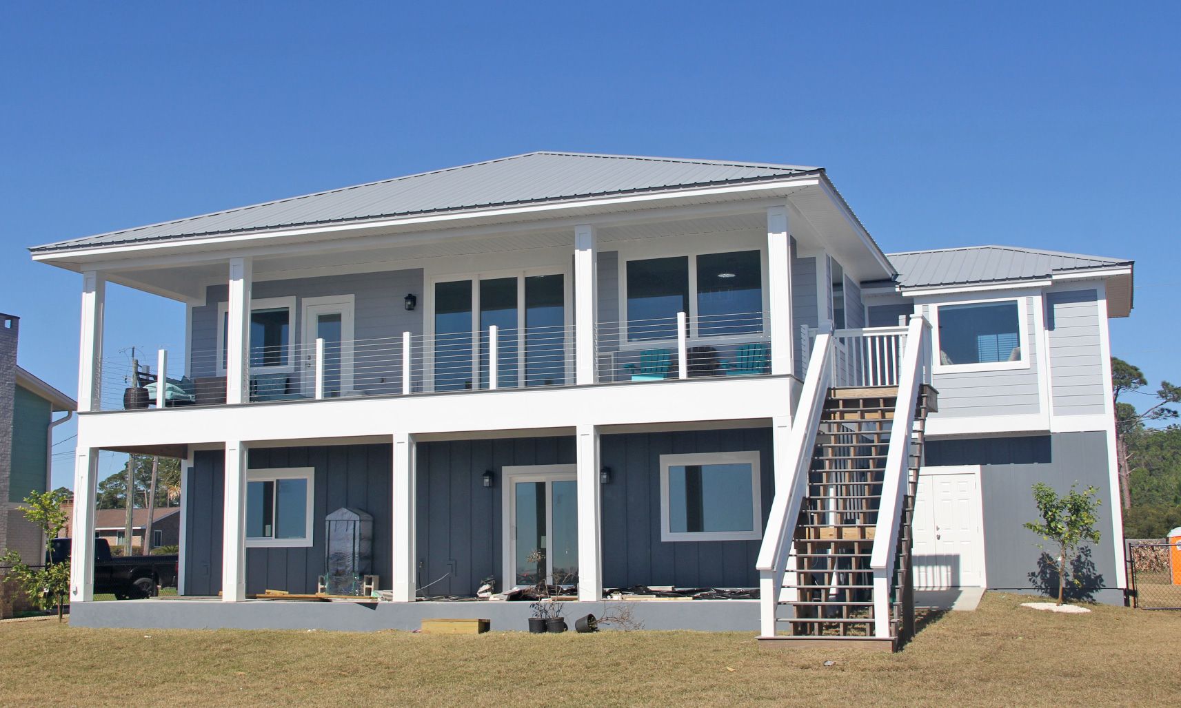 Smith coastal modern piling home on Navarre Beach by Acorn Fine Homes