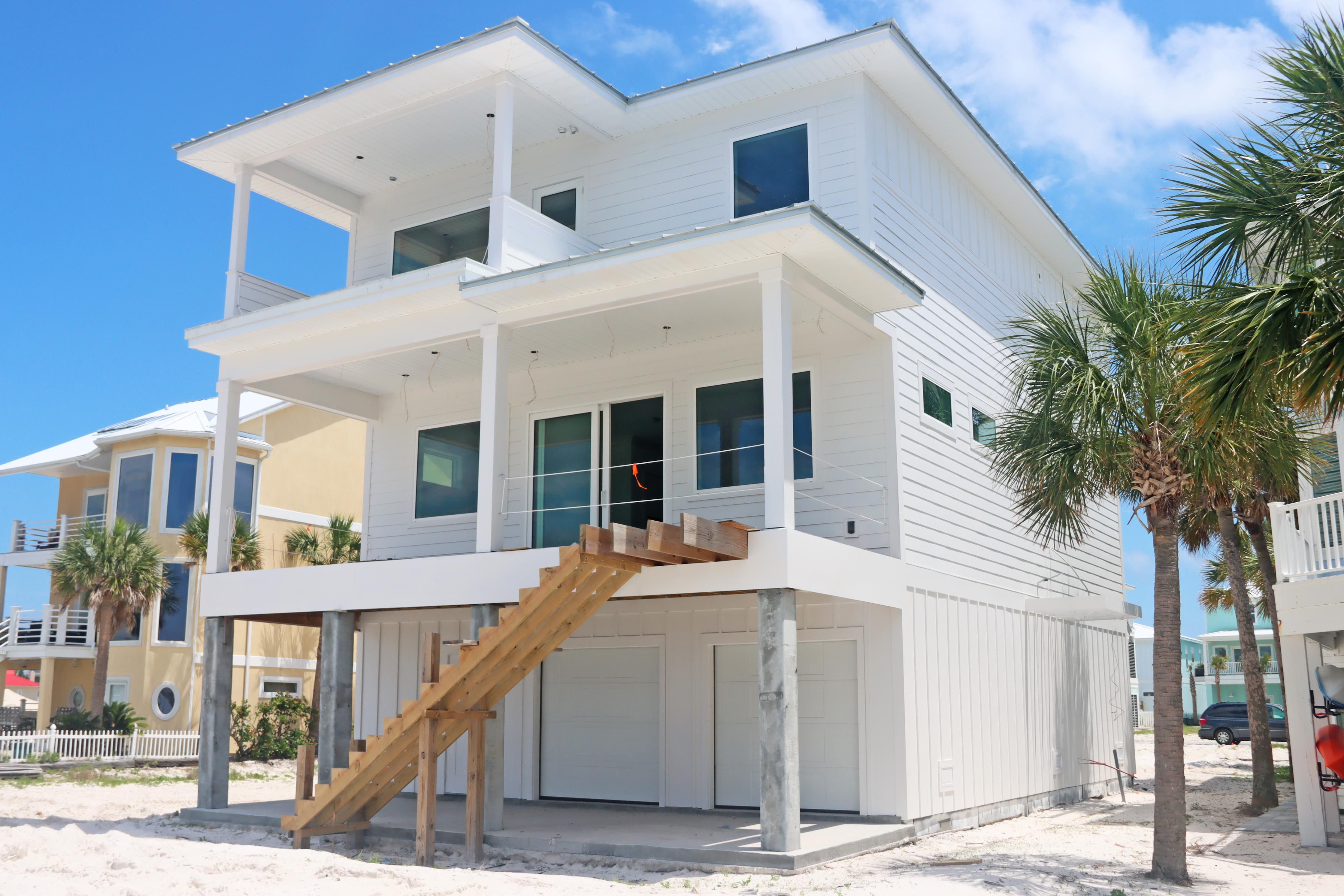 Modern coastal piling home in Navarre by Acorn Fine Homes