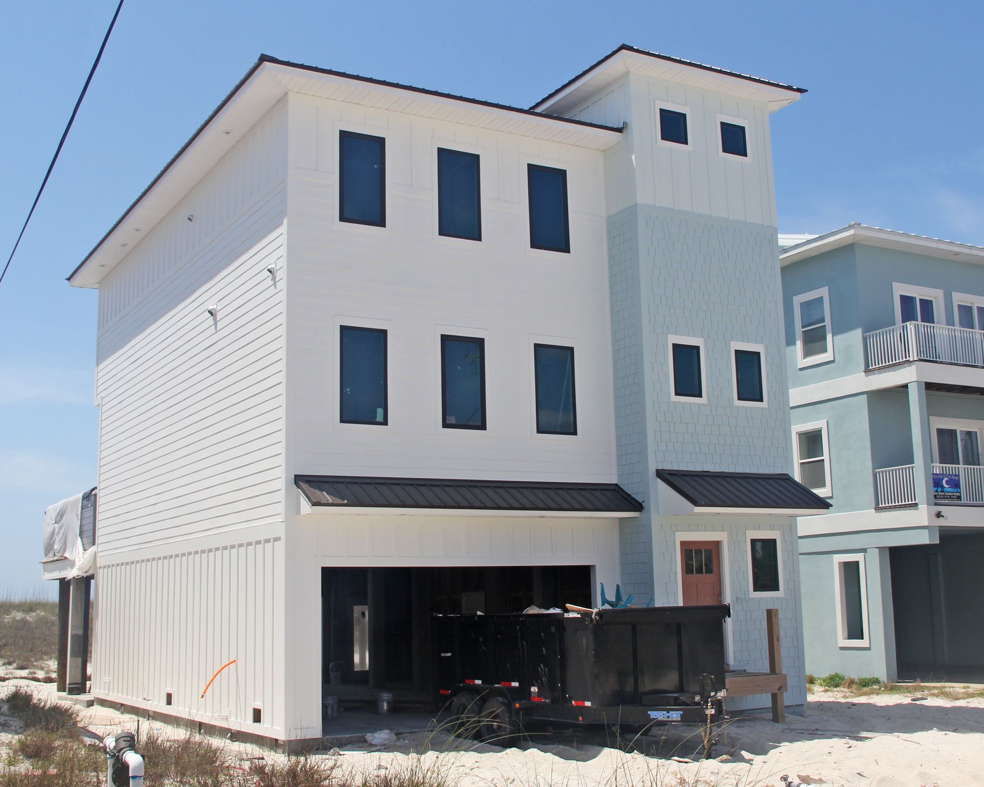 Davis modern coastal piling home on Navarre Beach by Acorn Fine Homes