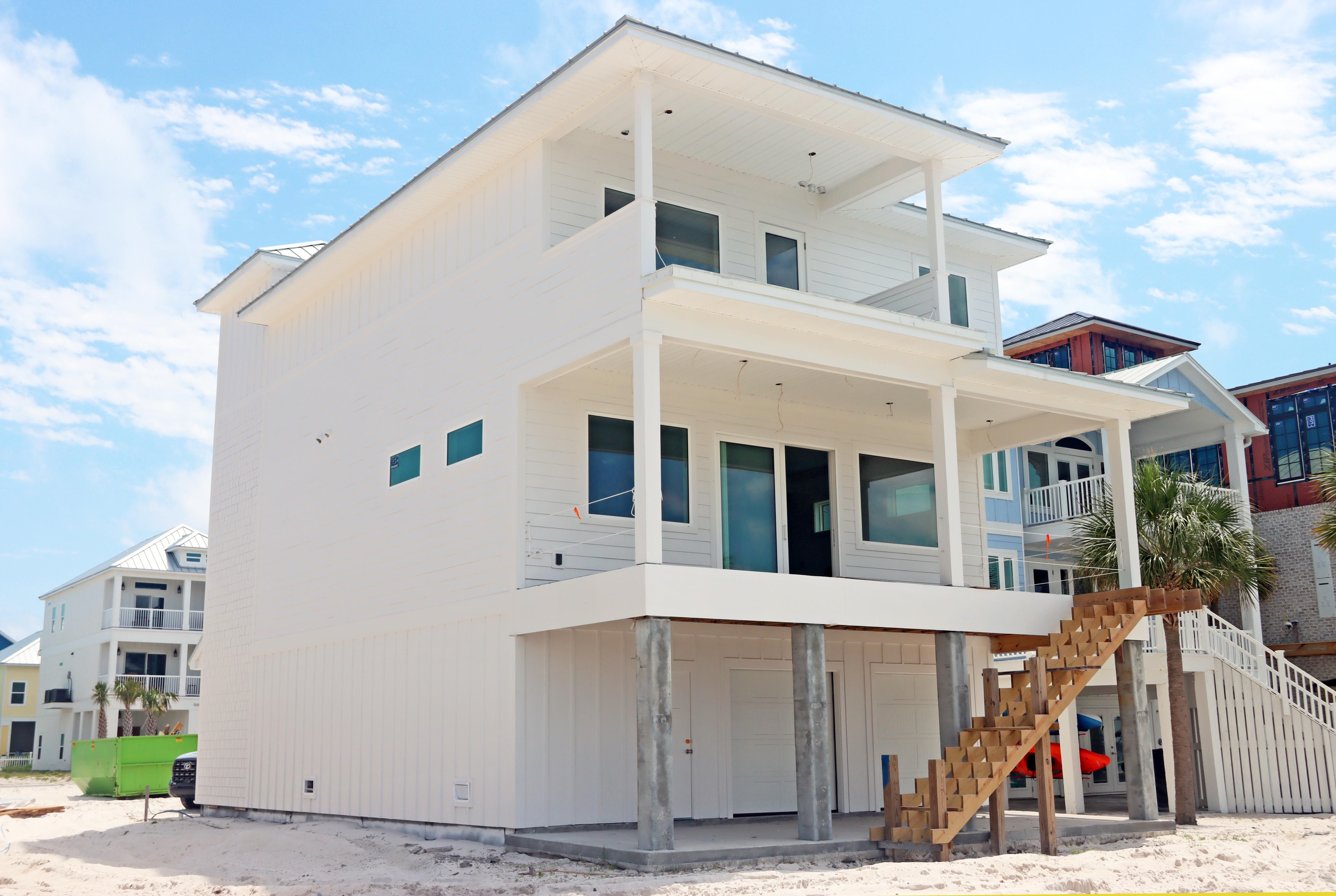 Modern coastal piling home in Navarre by Acorn Fine Homes