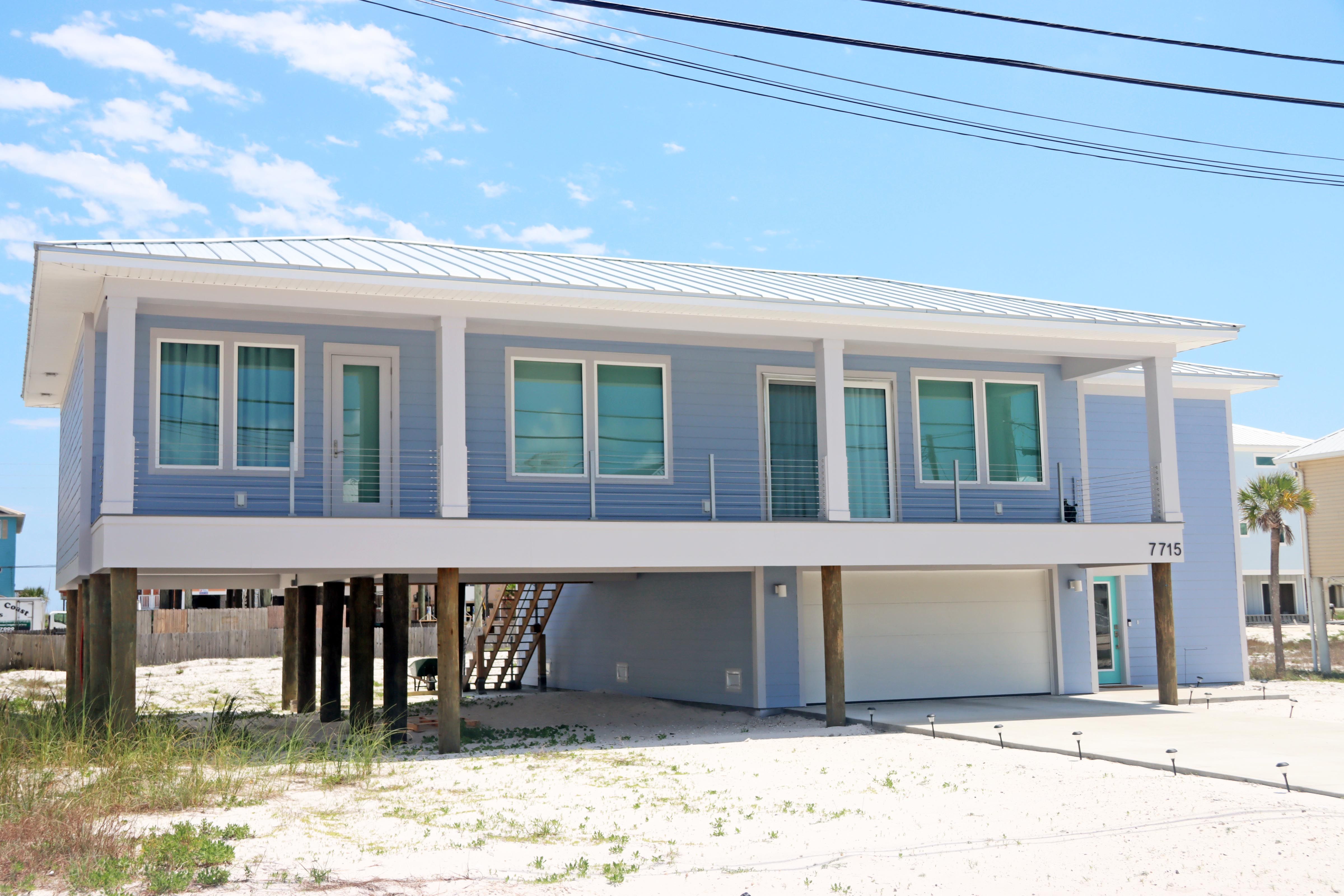 Modern coastal piling home in Navarre by Acorn Fine Homes